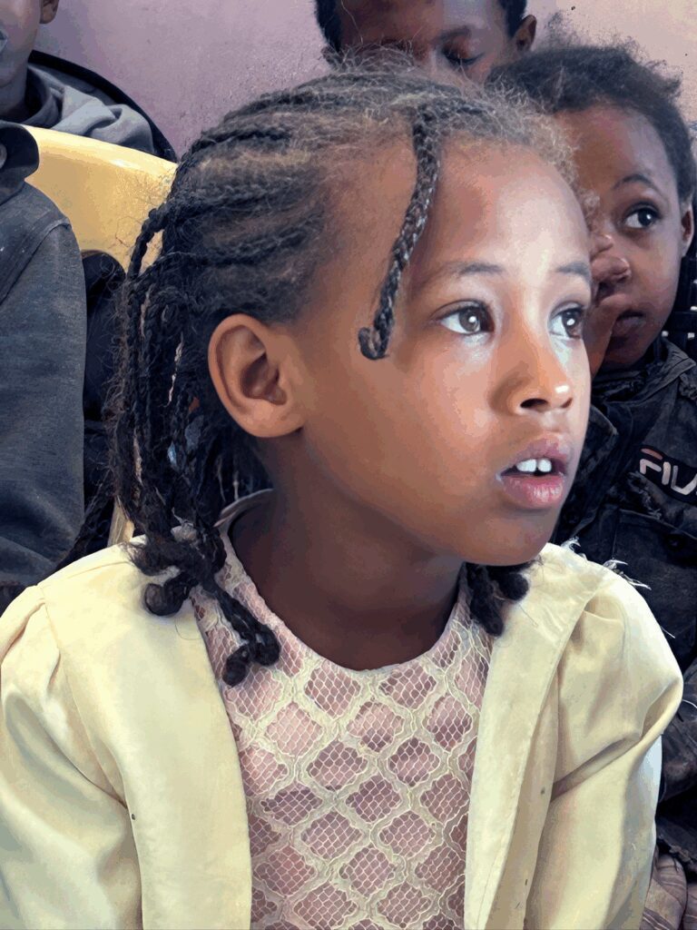 Ethiopian girl looking upward with hope at Adera Foundation's program in Addis Ababa