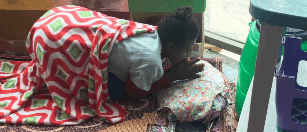 Young Ethiopian girl praying at Adera's preschool program in Addis Ababa